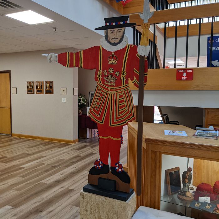 British Faire and Tea Beefeater Guard cutout points the way