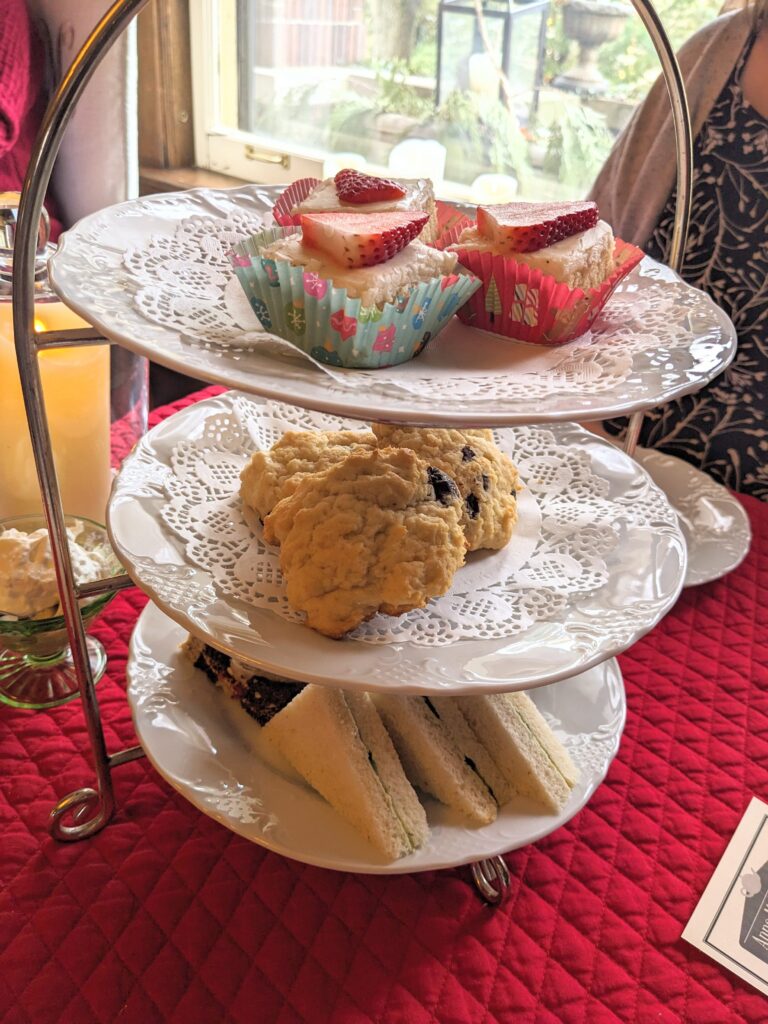 3 Tier Tray of tea foods, dessert, scones, and triangle crustless sandwiches.