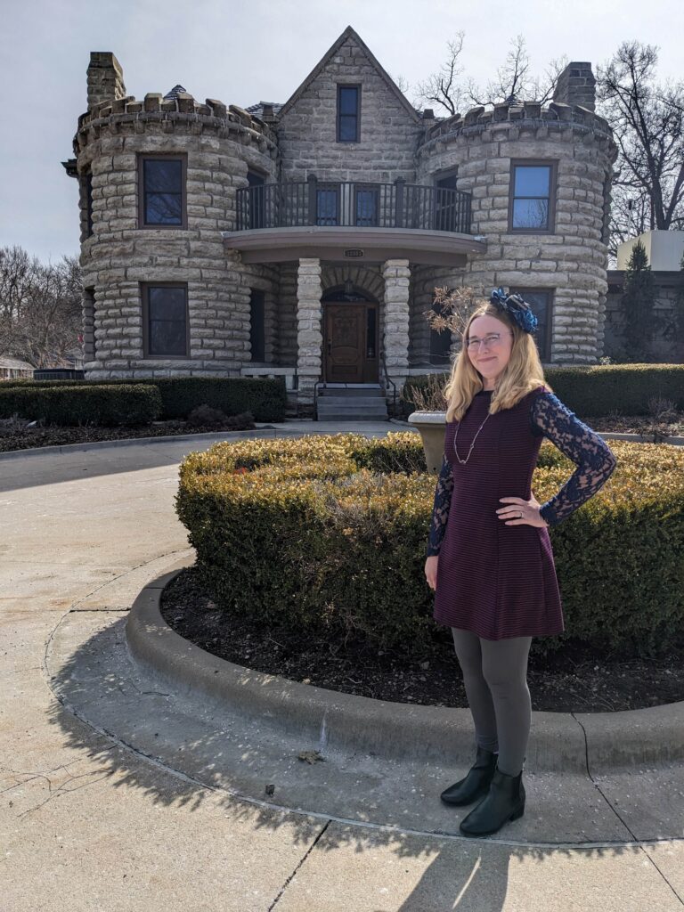 Lindsay in Tea Finery in front of Wandering Vine at the Castle