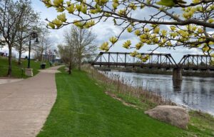 Eau Claire, Wisconsin path with grass and spring trees with a bridge over water